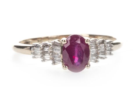 RUBY AND DIAMOND RING, the oval ruby flanked by tiered baguette cut diamonds totalling approximately 0.50 carats, marked 9K, 
