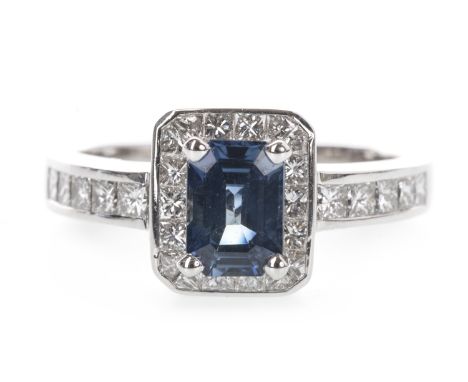 SAPPHIRE AND DIAMOND RING, the step cut sapphire within a halo of princess cut diamonds, on diamond set shoulders, the diamon