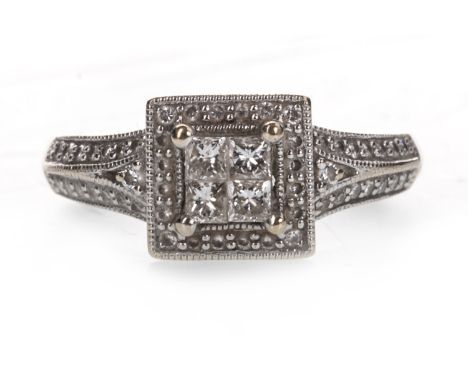 DIAMOND DRESS RING, set with four princess cut diamonds within a halo of round brilliant cut diamonds, on diamond set shoulde