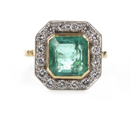 IMPRESSIVE GREEN GEM SET AND DIAMOND RING, the octagonal green gem measuring 9.3x9.3mm, within a halo of round brilliant cut 