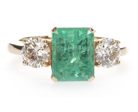 EMERALD AND DIAMOND THREE STONE RING, the step cut emerald of approximately 2.32 carats flanked by two round brilliant cut di