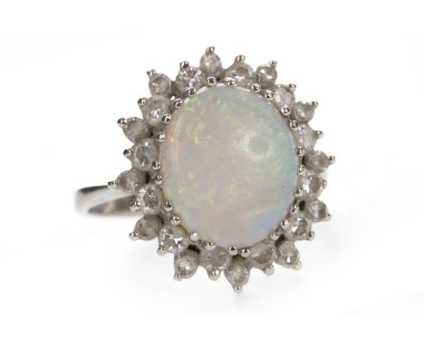 OPAL AND DIAMOND RING, the oval opal 8mm long, within a double halo of round brilliant cut diamonds totalling approximately 0