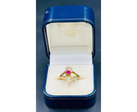 A 9ct gold ring with ruby and diamond bow theme, approximate weight of 4.9g