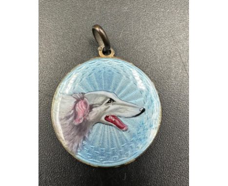 A blue guilloche enamel pendant featuring a Russian wolf hound 