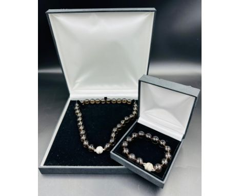 A glass bead necklace and bracelet set with silver ball fastener 