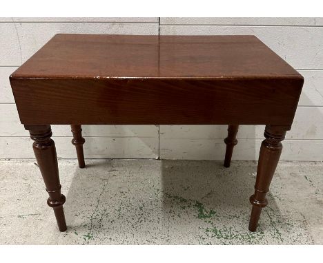 An Edwardian mahogany babies bath with ceramic insert and turned legs 