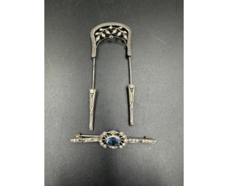 A silver Art Deco style brooch with a light blue central stone marked 900 and a Georgian hair pin 