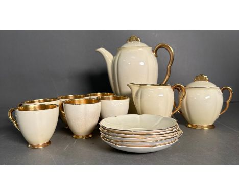 A part Carlton ware Art Deco Rita coffee set, the set having ivory bodies with gilt interior and handles with fan shaped sauc