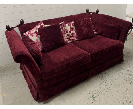 A deep red velvet sofa with drop sides (H79cm W220cm D108cm)