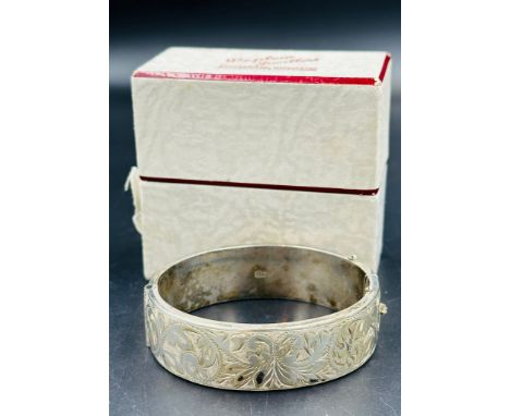 A decorative silver bangle 