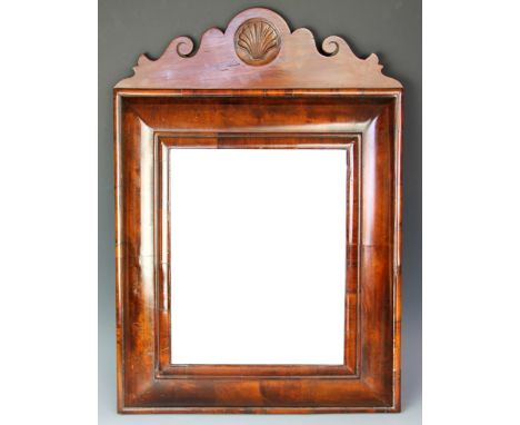 An 18th century and later walnut cushion frame wall mirror, with shell carved serpentine cresting rail, 57cm H x 40cm W