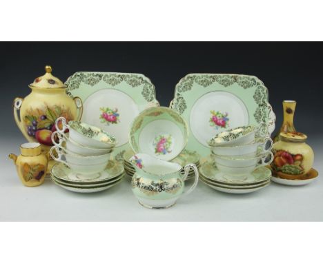 A Foley China part tea service, each piece decorated in gilt against a light green ground with a central floral spray, compri