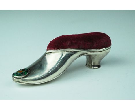 A silver shoe pin cushion, William Hair Haseler, probably Birmingham 1906, in typical Liberty style, set with enamelled round
