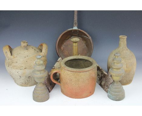 Three 19th century stoneware vessels, to include a twin handled example, a pair of cast iron fire dogs, a brass chamber stick