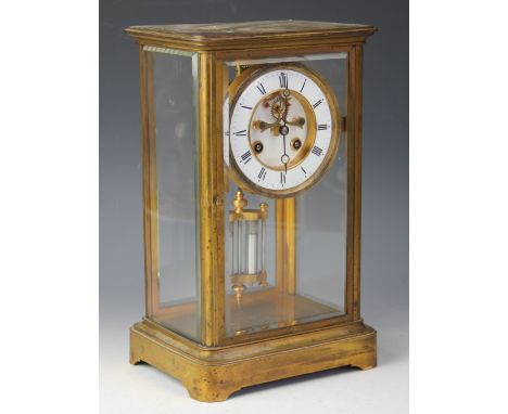 A 19th century French lacquered brass eight day four glass mantel clock, with enamel Roman numeral chapter ring and visible e