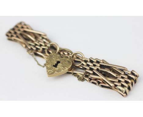 A decorative yellow metal Victorian bracelet, of decorative gate style and with X links, later attached padlock clasp stamped