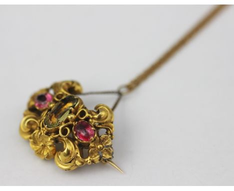 A Victorian tourmaline and peridot? set brooch/pendant, (a later conversion) of scroll work yellow metal design and with lock