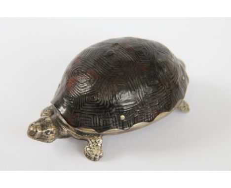 A late Victorian novelty tortoise table vesta, with white metal body and hinged tortoiseshell cover, 8.5cm long with a barrel