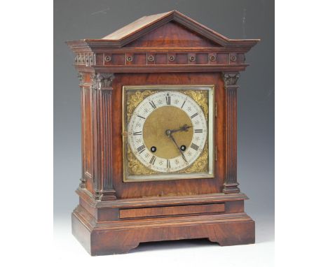 A late Victorian walnut eight day mantel clock, brass dial with Roman numeral chapter ring and movement striking on a two gon