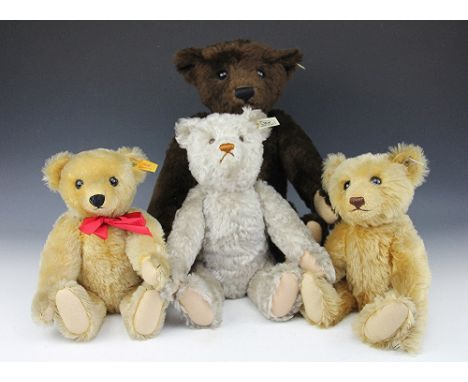 A Steiff brown teddy bear, with growler, 55cm, with two smaller gold plush bears and a pale plush bear, all with growlers, an