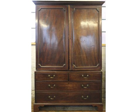 A late George III mahogany linen press, with two panelled doors above two short and two long drawers, on bracket feet, 204cm 