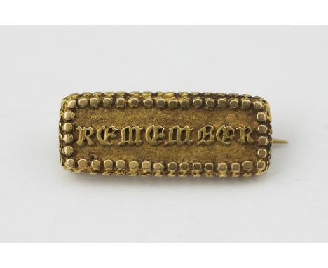 A Victorian yellow metal 'Remember' brooch, the hinged front opening to reveal plaited hair, engraved to the back 'W.W Hender