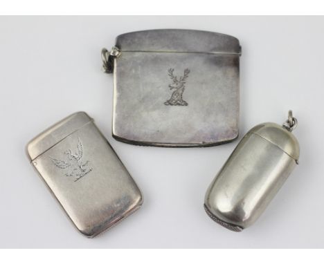 Three silver vesta cases to include; a George V cushion shaped example, William Neale, Birmingham 1910, engraved with stags h