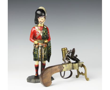 A table tinder lighter with flintlock pistol mechanism and candlestick sconce to the side, stamped 'Willson and Co London', 1