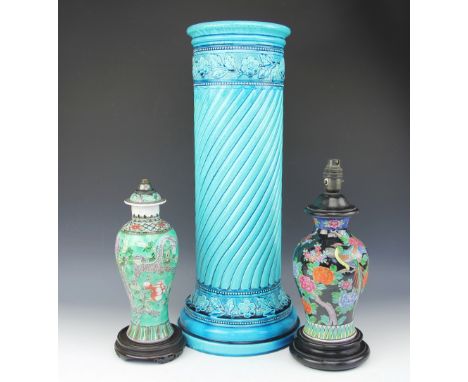 A large Burmantofts Faience turquoise glazed relief moulded pedestal, 64cm high, with two Chinese lamp bases comprising a fam