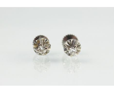 A pair of diamond set stud earrings, each claw set in white metal, unmarked, gross weight 1.7gms