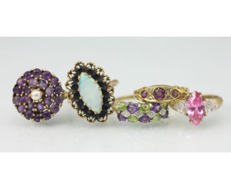 Five dress rings, to include; an opal and sapphire marquise shaped ring, an amethyst and pearl set target ring, an amethyst a