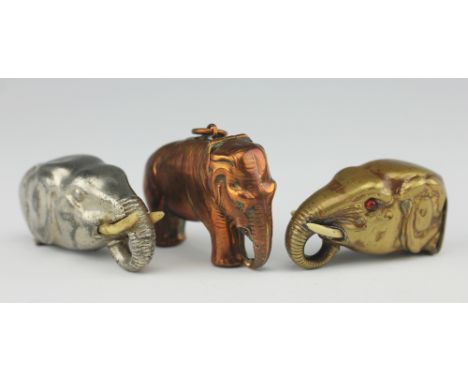 Three elephant vesta cases, to include; a brass 'head' 5cm long and another in white metal 6cm long and a copper whole elepha