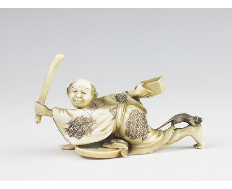 A Japanese ivory okimono of a ratcatcher, Meiji period 1868-1912 the figure crouching and holding a stick and a tray in each 