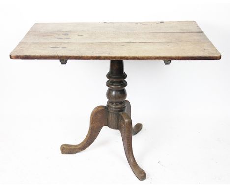 A George III oak occasional table, with three plank rectangular top, on a turned column and tripod base, 74cm H x 100cm W x 6