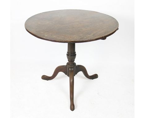 A George III mahogany tilt top occasional table, with circular top, on a turned column and tripod base, 74cm high x 82cm diam