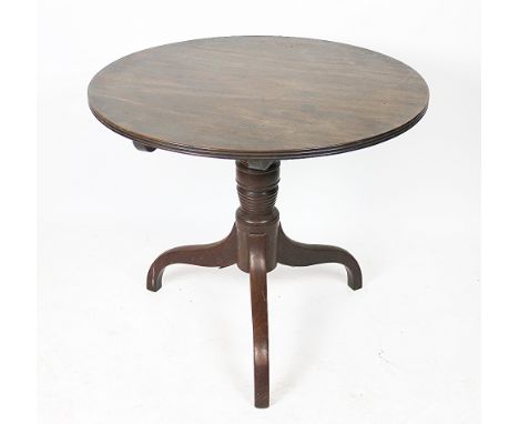 An early 19th century mahogany tilt top occasional table, with circular top, on a turned column and tripod base, 65cm H x 74c