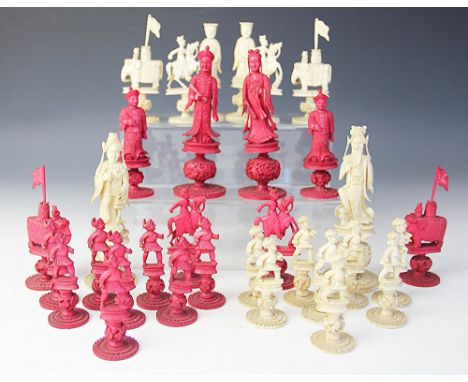 A 19th century Cantonese carved and stained ivory chess set, with foliate carved ball supports and circular bases, kings 13.5