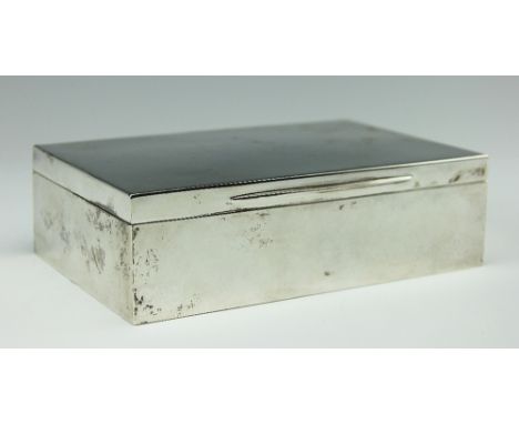 An Edwardian silver smokers box, Charles Henry Dumenil, London 1910, of plain rectangular form, the hinged lid enclosing gilt