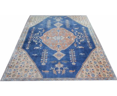 A Caucasian wool carpet, worked with an all over foliate design, against a blue ground, 355cm x 283cm (at fault)