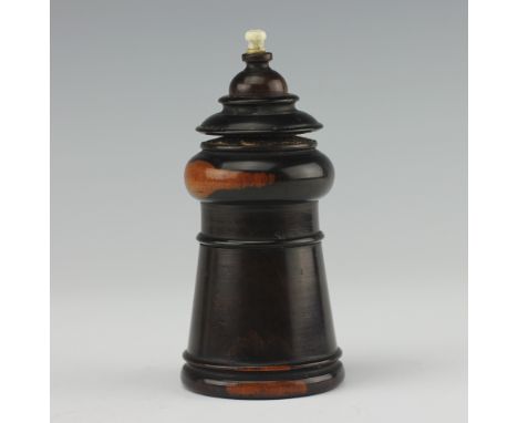 A Coombs and Co lignum vitae vesta, striker and go-to-bed, designed in chess piece form, unscrewing to reveal vesta compartme