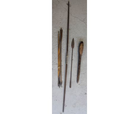 TRIBAL - a wooden bow along with 5 cane arrows with metal arrow heads, one with flight, an African wooden club and an iron sp