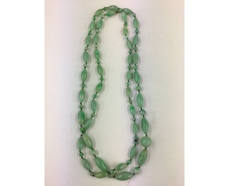 Art Deco period Light green Jade necklace, with different cut beads, with central circular bead hanging to the base, well str