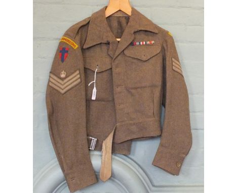 A 1945 dated blouse with insignia to Royal Armoured Corps and three medals, War medal, Defence medal with France and Germany 