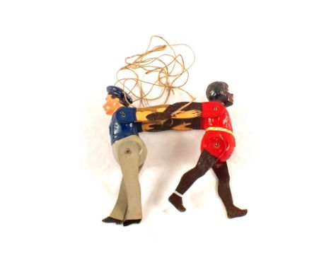 A painted wooden ethnic boy and sailor string puppet