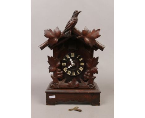 A Black Forest pine cased cuckoo clock with 30 hour movement and key.