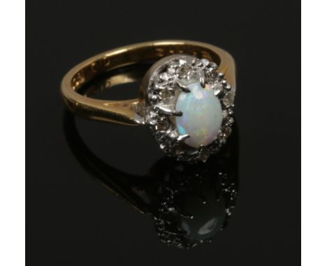 An 18ct gold opal and diamond ring, size L