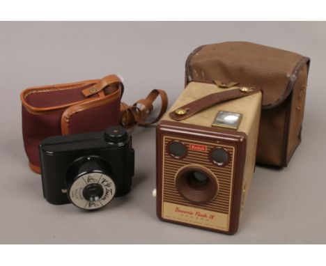 A 1930s black bakelite V. P. Twinroll film camera with bloomed bolco lens and carry case along with a cased Kodak Brownie fla