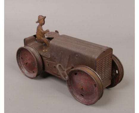 A vintage Louis Marx &amp; Co clockwork tin tractor with farmer at the wheel with key.