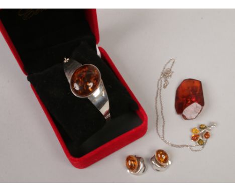 A silver and amber bangle, pair of earrings, pendant on chain and brooch.