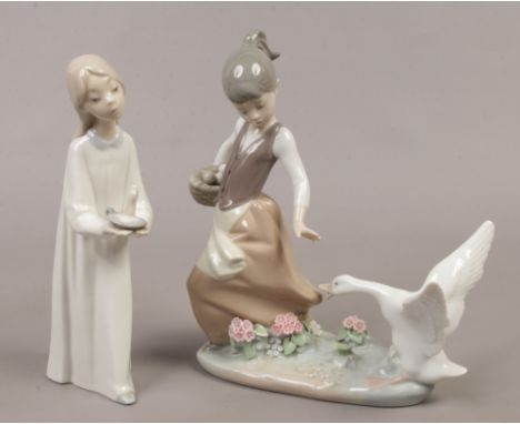 Two Lladro porcelain figures of young girls on fending off a goose, the other holding a chamber stick.Condition report intend